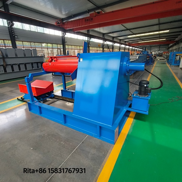 Real photo of hydraulic decoiler with motorized trolley installed in customer factory, showing actual working environment and integration with roll forming production line