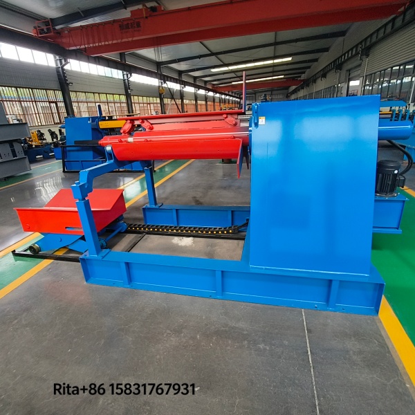 Automatic motorized trolley loading steel coil onto hydraulic decoiler, demonstrating smooth rail-guided movement and precise positioning for automated roll forming line